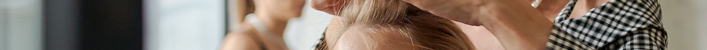 Hairdresser straightening a client's hair in a modern beauty salon